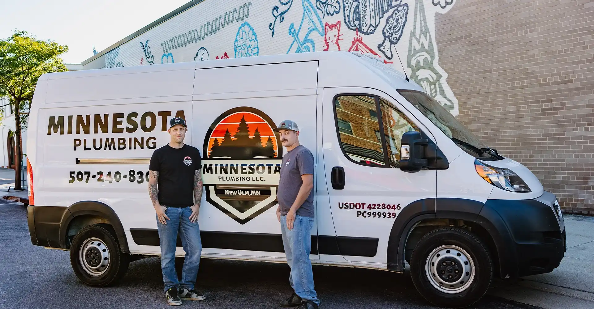 Minnesota Plumbing team standing in front of a company service van